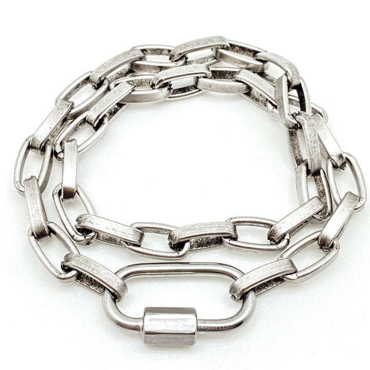 A chunky silver paperclip double wrap bracelet-necklace with carabiner link.