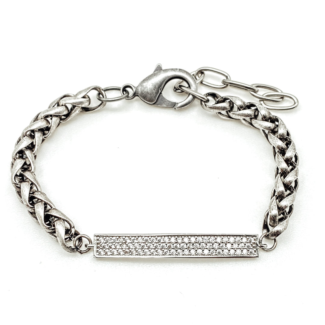 A silver chainlink bracelet with pave bar connector.
