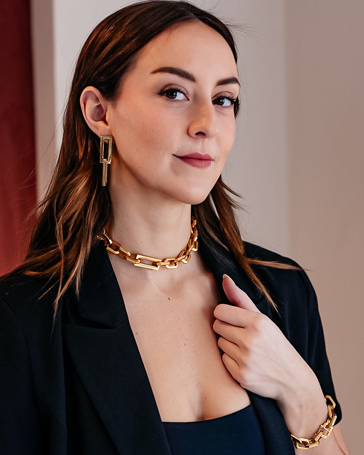 A model wearing A chunky hexagon shaped link necklace with CZ detail on each link.