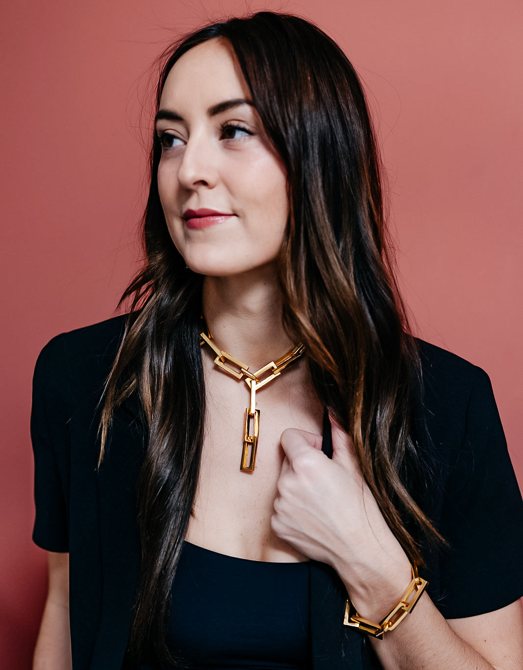 A model wearing A gold chunky rectangle link necklace with a pave clasp.