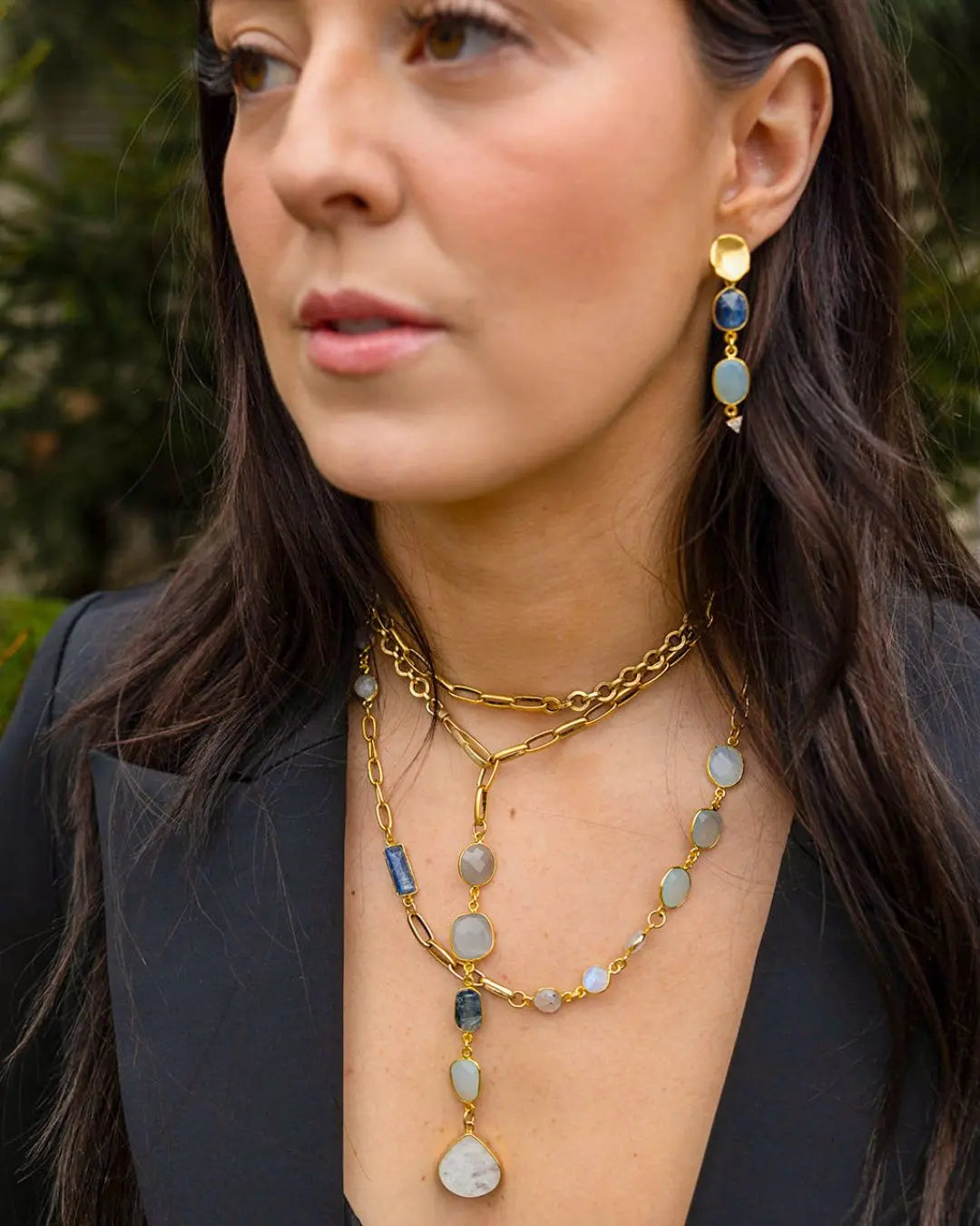 Model showcasing Loni Paul affordable luxury jewelry, featuring a stunning gemstone necklace and earrings crafted with high quality materials.