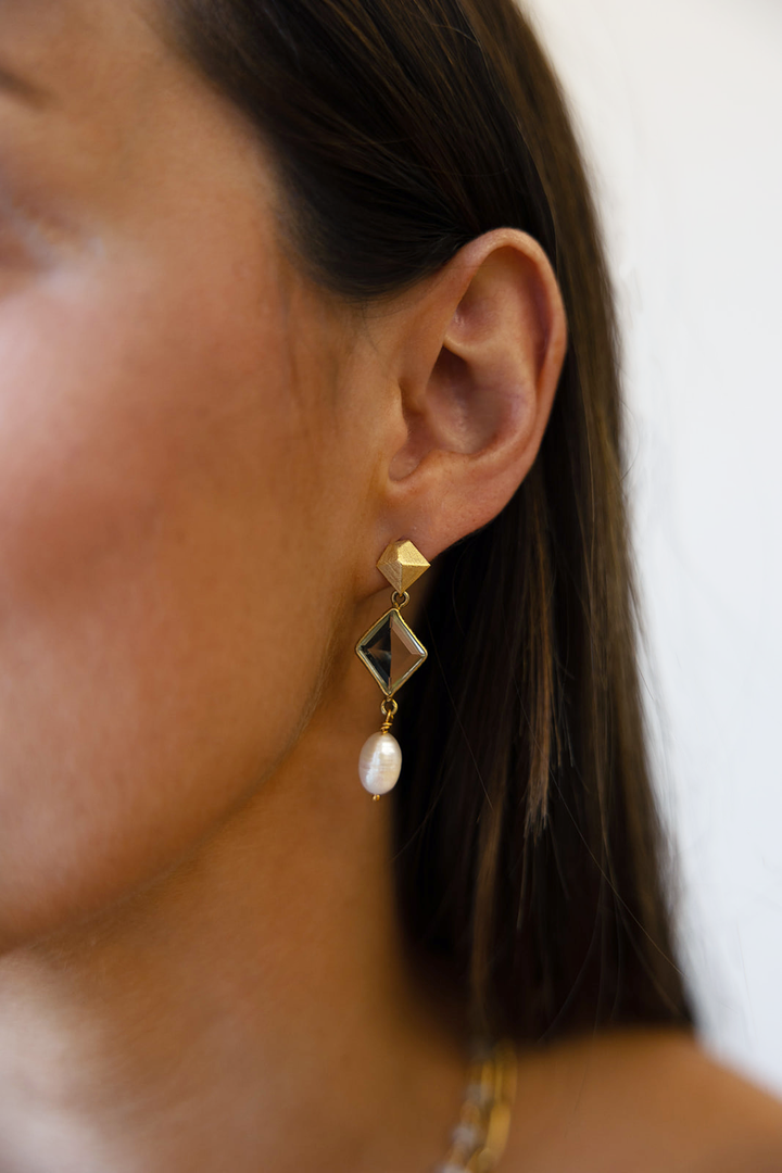 an asymmetrical quartz earring with a pearl dangle