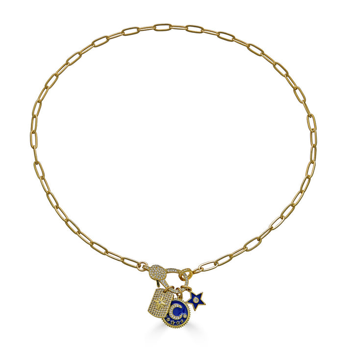 A matte gold paperclip chain necklace with a blue moon, north star, and circle charm with a pave lobster claw.