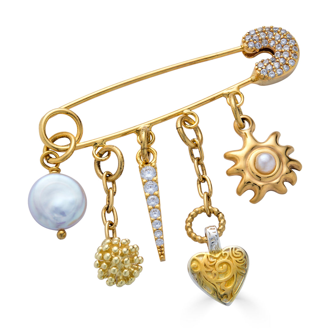 Gold celestial brooch pin with dangling pearl, crystal pavé charm, heart pendant, textured orb, and sunburst charm.