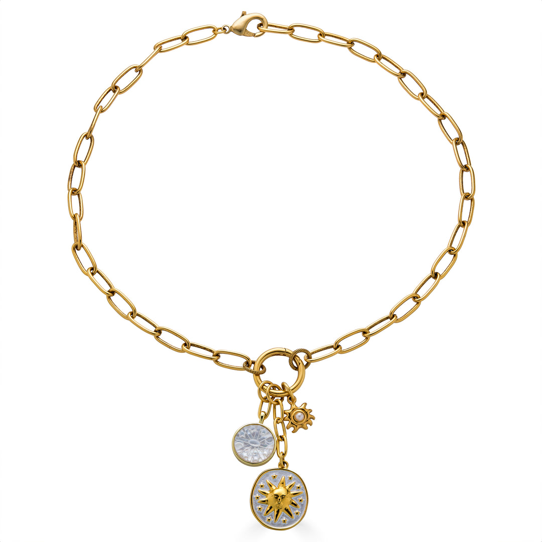 Gold paperclip chain necklace with enamel celestial charms, mother-of-pearl detail, and a sun medallion pendant.