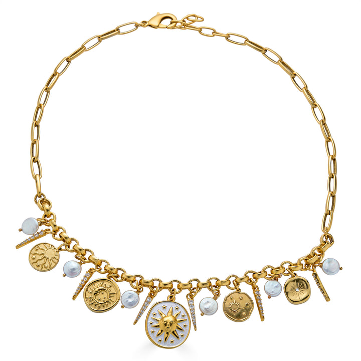 Gold celestial charm necklace with sun medallions, coin pearls, pavé crystal accents, and dangling celestial charms on a chunky chain.