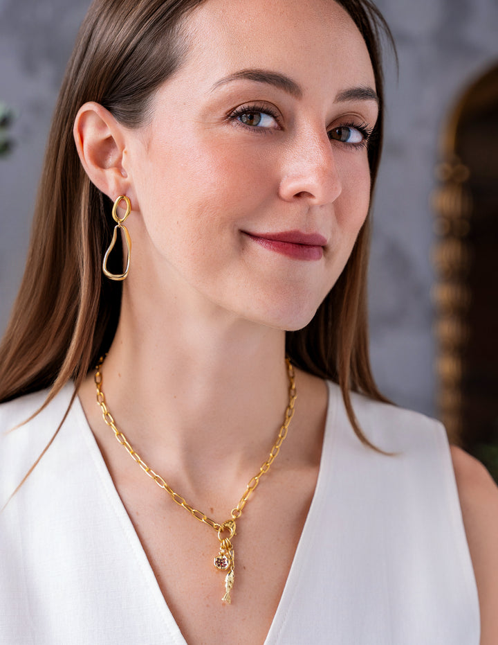 Gold organic shape drop earrings with abstract open sculptural design.
