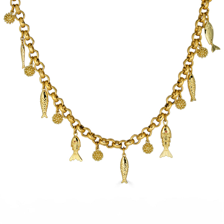 Convertible gold fish charm necklace with dangling fish and textured bead charms worn as both a lariat and classic chain necklace.