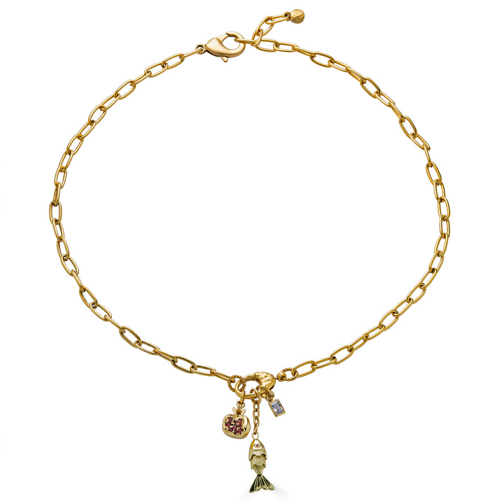 Gold chain necklace with fish charm, pomegranate charm, and crystal accents.