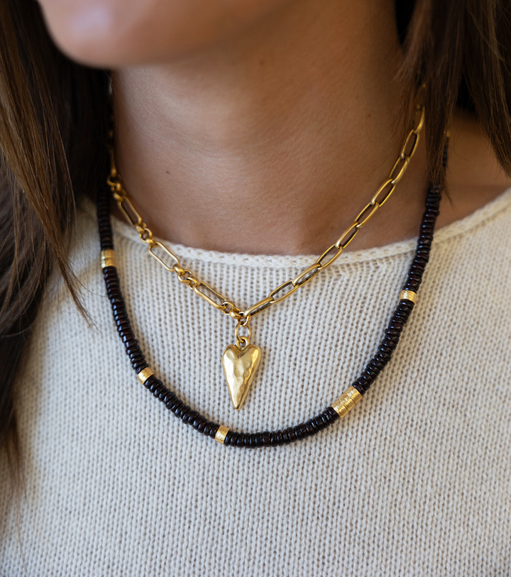 A garnet necklace with brushed gold spacer beads.