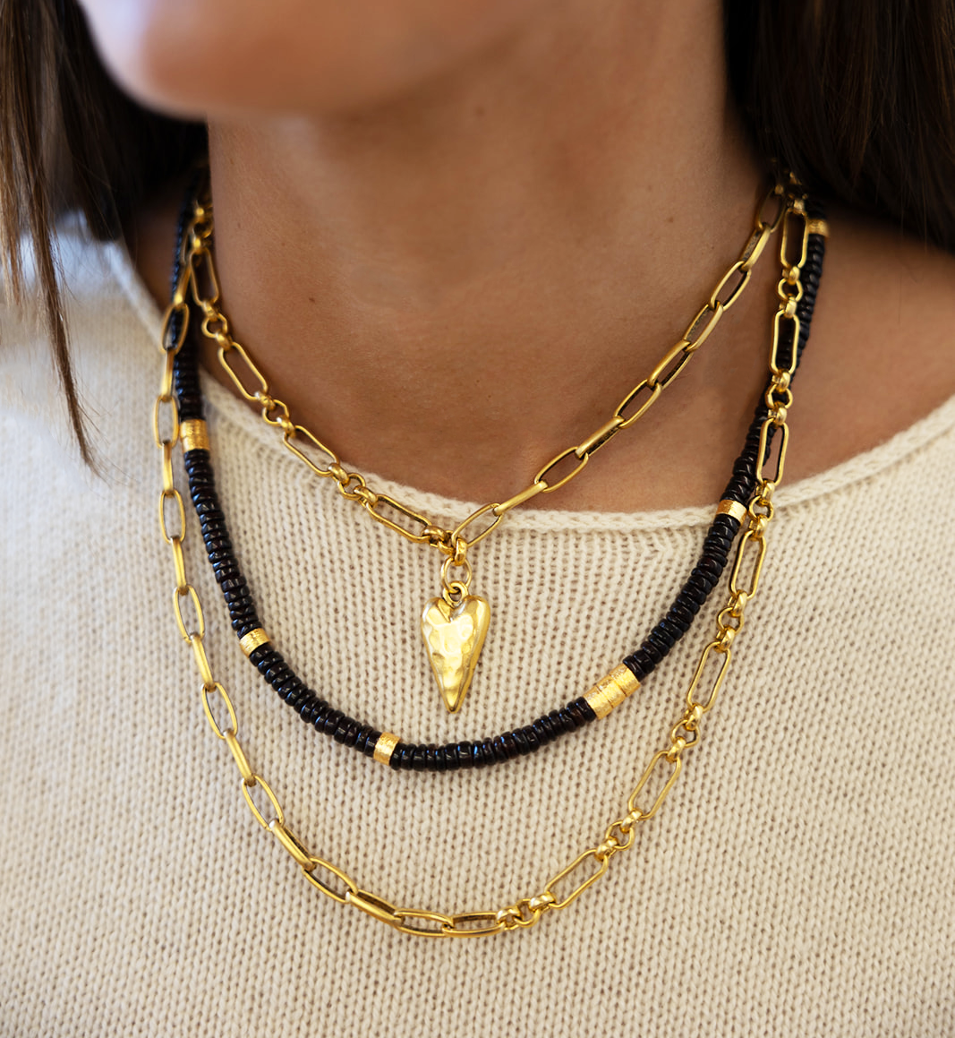 A garnet necklace with brushed gold spacer beads.