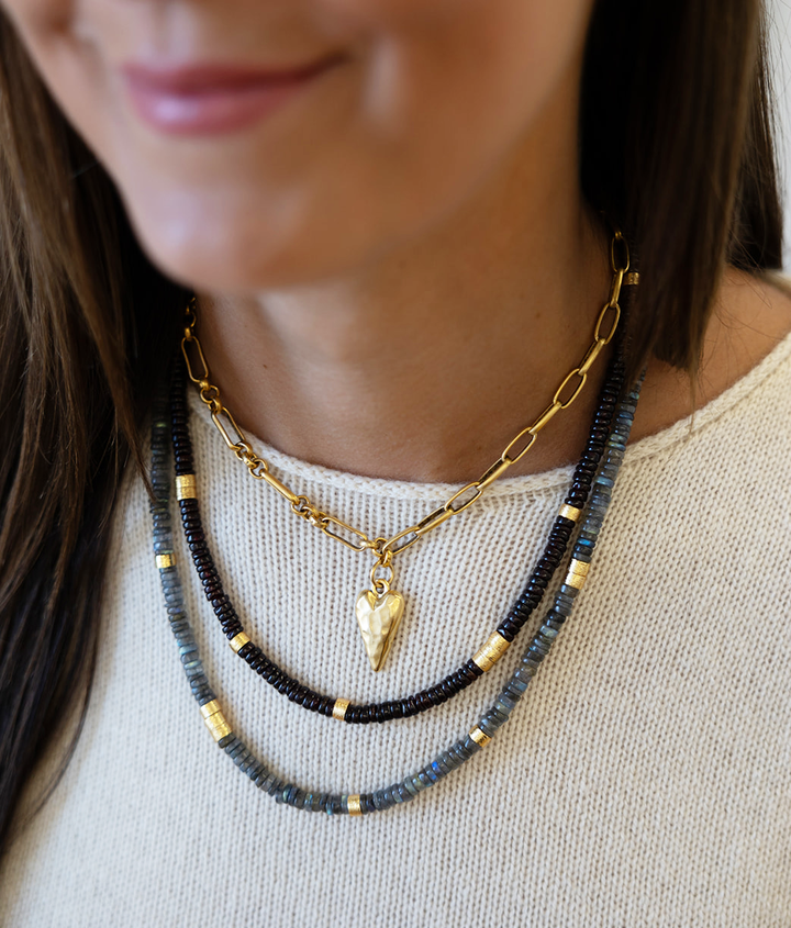 A garnet necklace with brushed gold spacer beads.