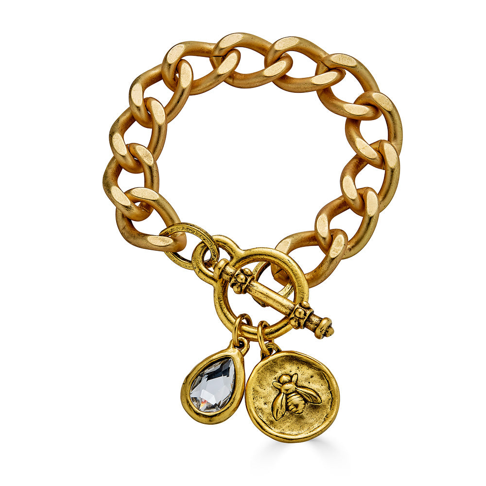 A matte gold chunky curb chain bracelet with oval bee and crystal charms.