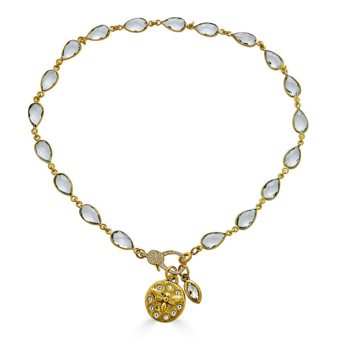 A gold crystal chain necklace with a crystal bee charm