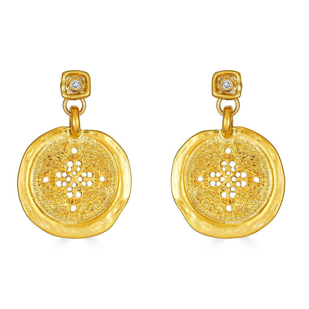 A hammered filagree gold coin earring on a square crystal post