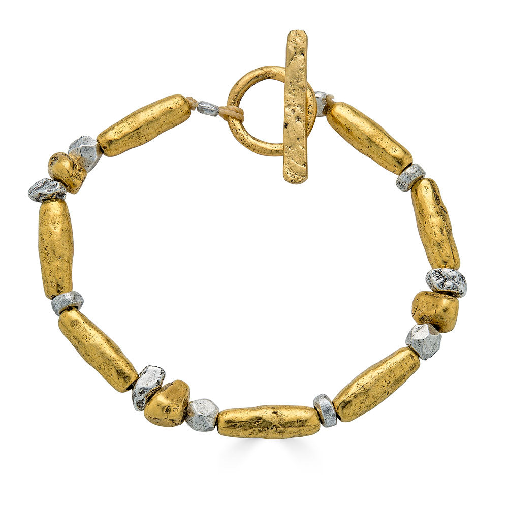 Gold and silver-toned bracelet with organically shaped mixed metal beads and a toggle clasp.
