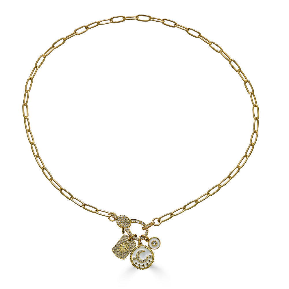 A matte gold paperclip chain necklace with a white moon, north star, and circle charm with a pave lobster claw.