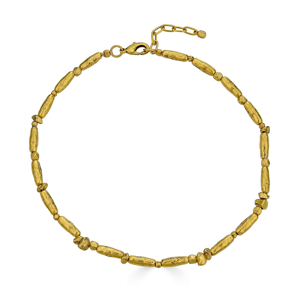 Gold necklace with organic, elongated and irregular bead shapes spaced along a double strand chain, finished with an adjustable clasp.