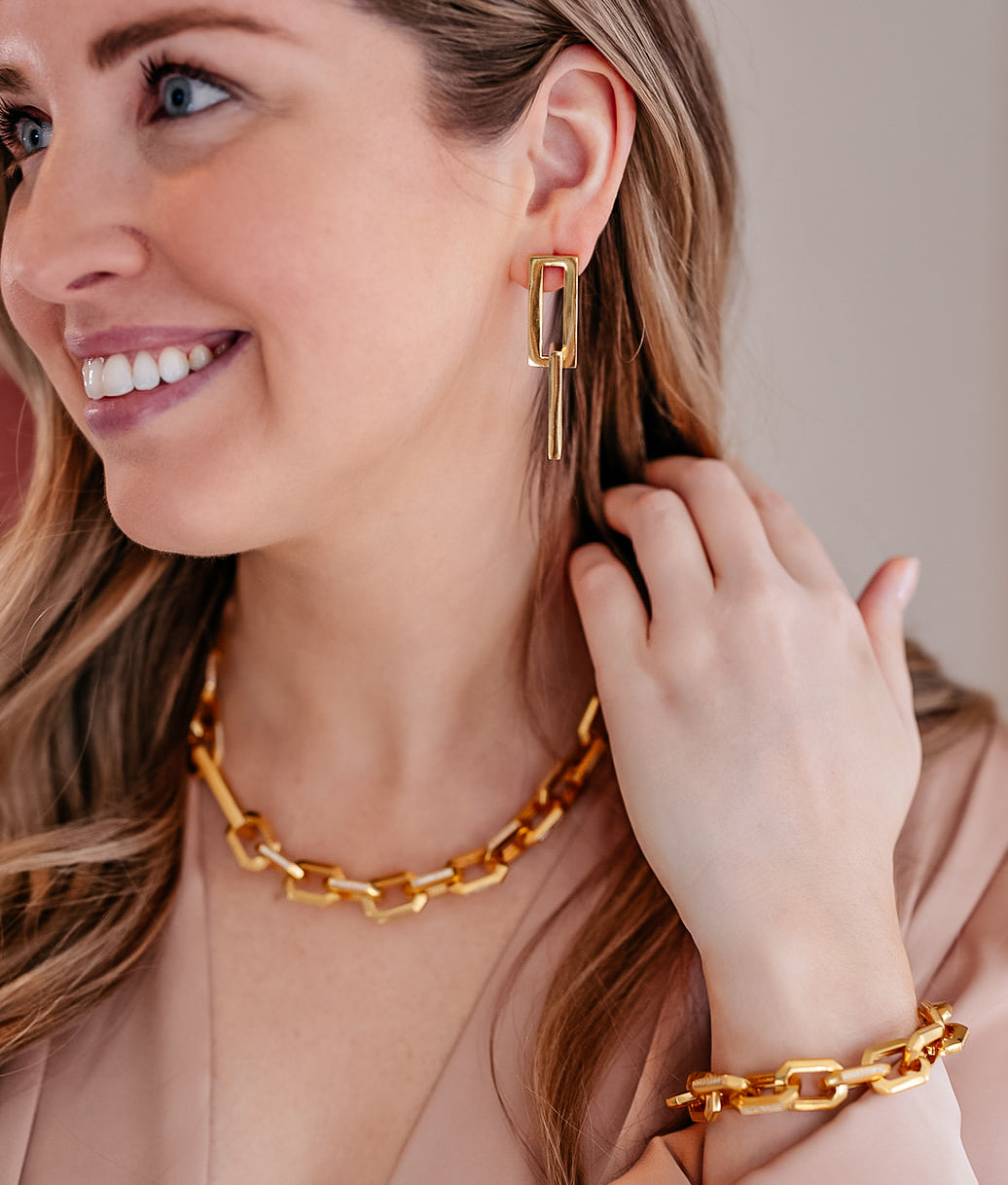 A model wearing A chunky hexagon shaped link necklace with CZ detail on each link.
