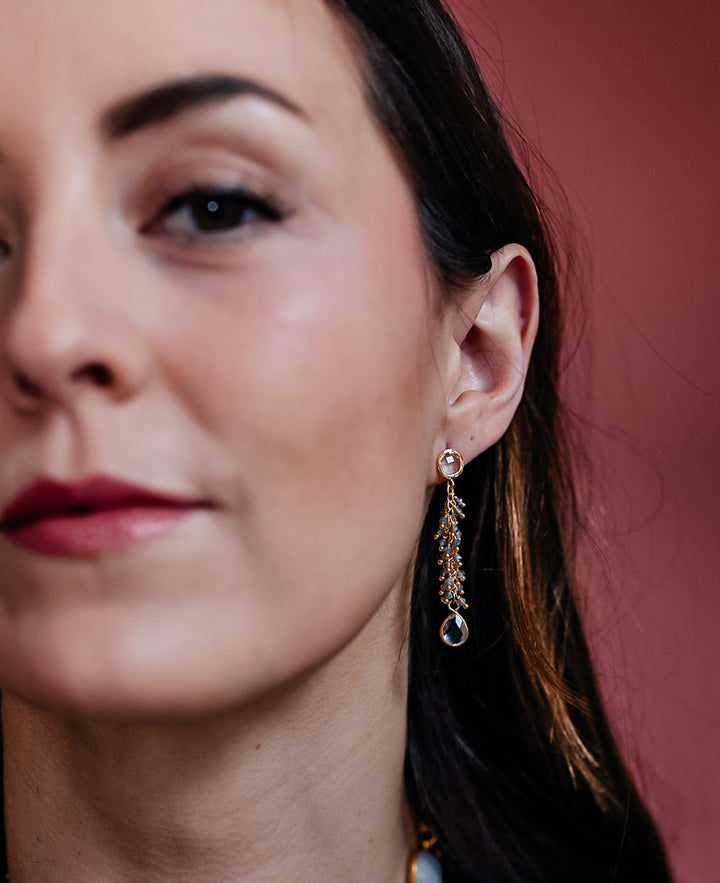 a model wearing Labradorite drizzle on a crystal post with a crystal drop