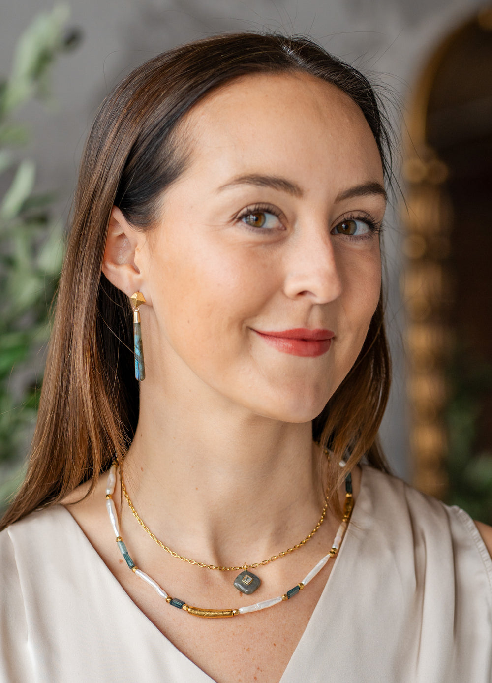 Labradorite pendant necklace with square white topaz inlay on a gold-plated chain.