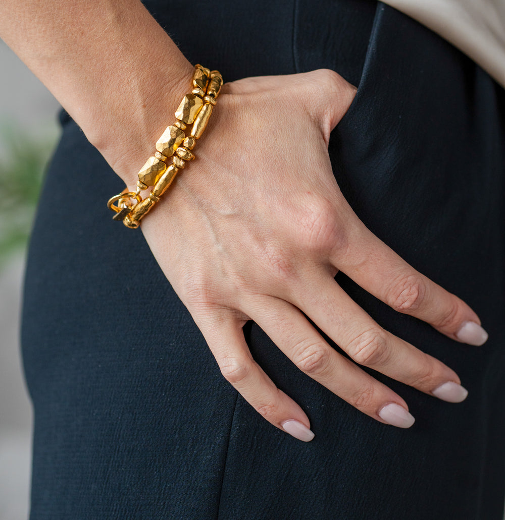 Bracelet featuring faceted rectangular gold beads with matte finish and toggle clasp.