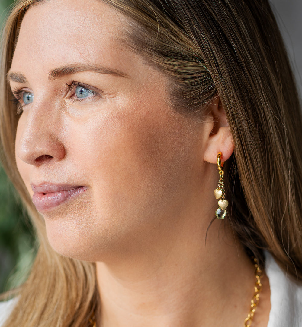Gold drop earrings with brushed heart top and three dangling strands featuring smoky gem, crystal, and spike charms