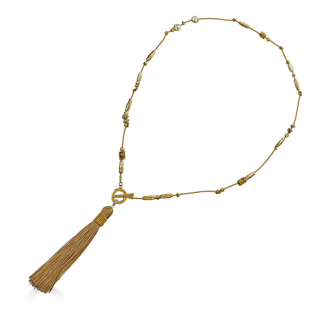 Handmade gold tassel necklace with organic bead accents and silk tassel detail