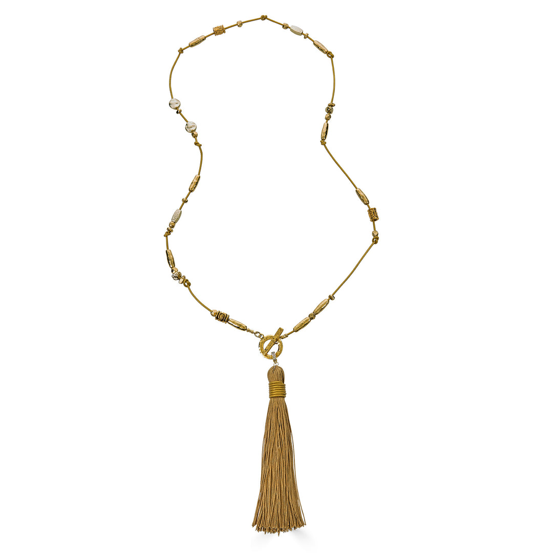 Handmade gold tassel necklace with organic bead accents and silk tassel detail