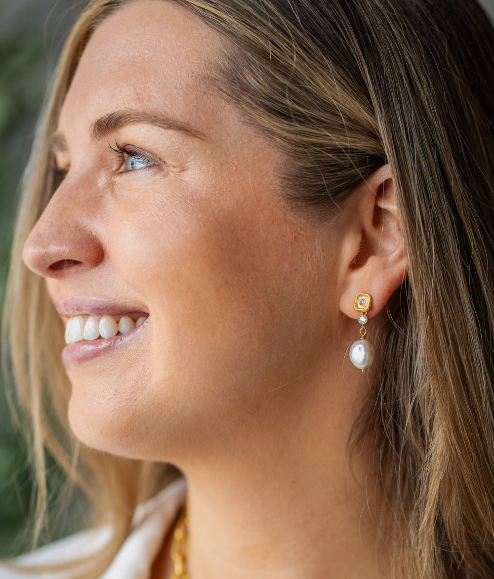 Gold drop earrings with unique Keshi pearls and two crystal accents on a textured post