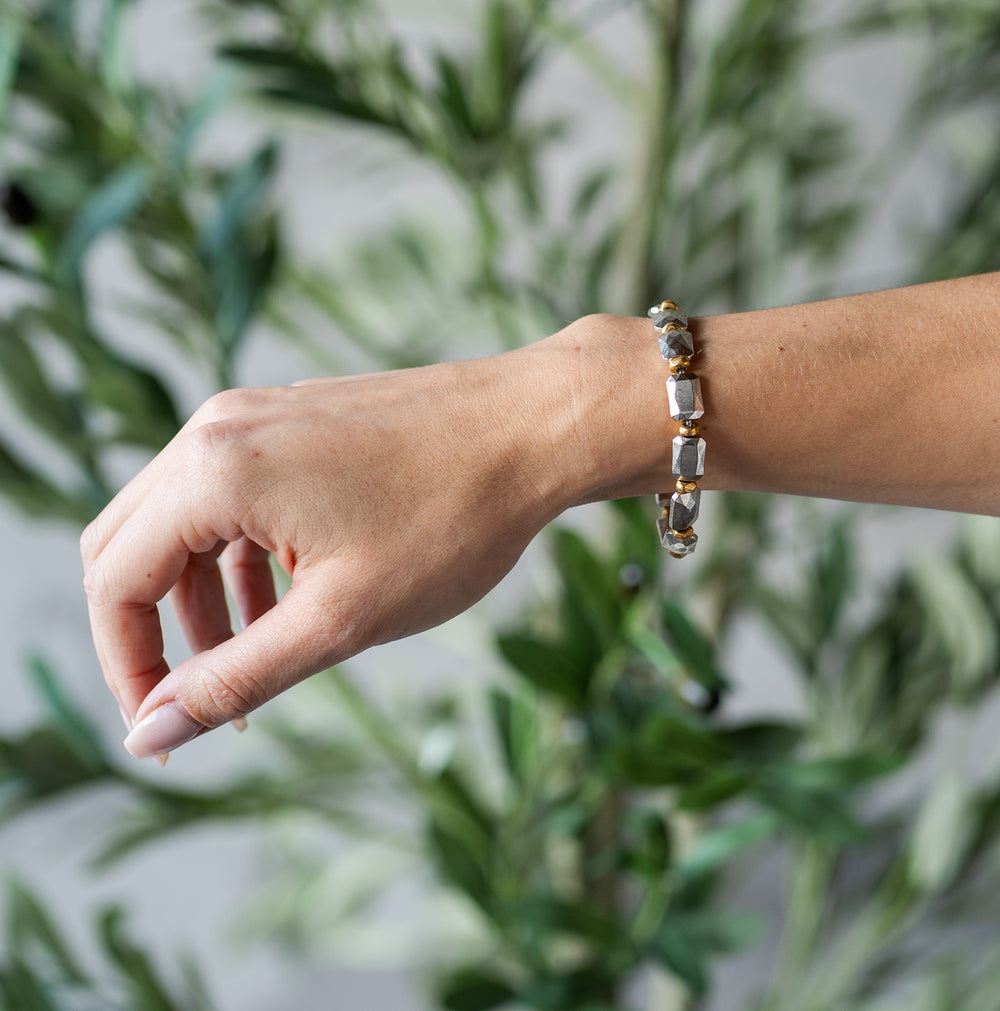 Bracelet with silver faceted rectangular beads and gold spacers, finished with a toggle clasp.