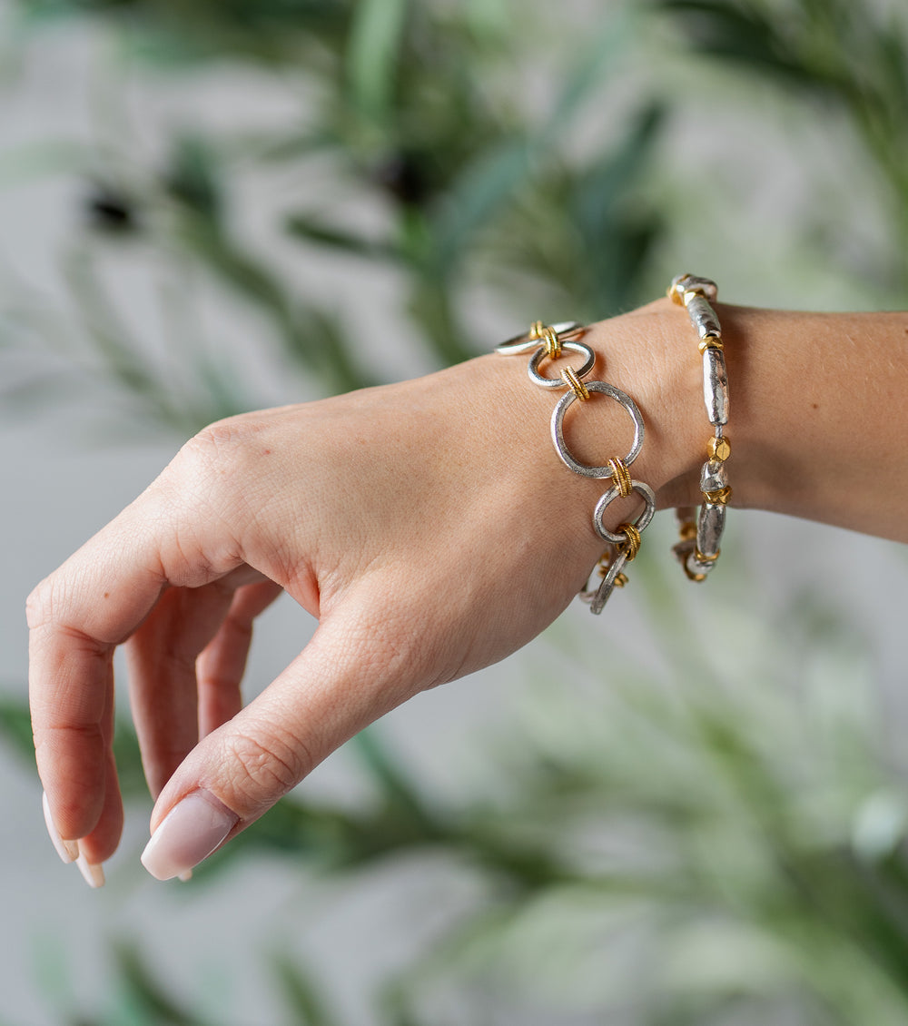 Silver and gold-toned bracelet with mixed metal organic beads and a toggle clasp.