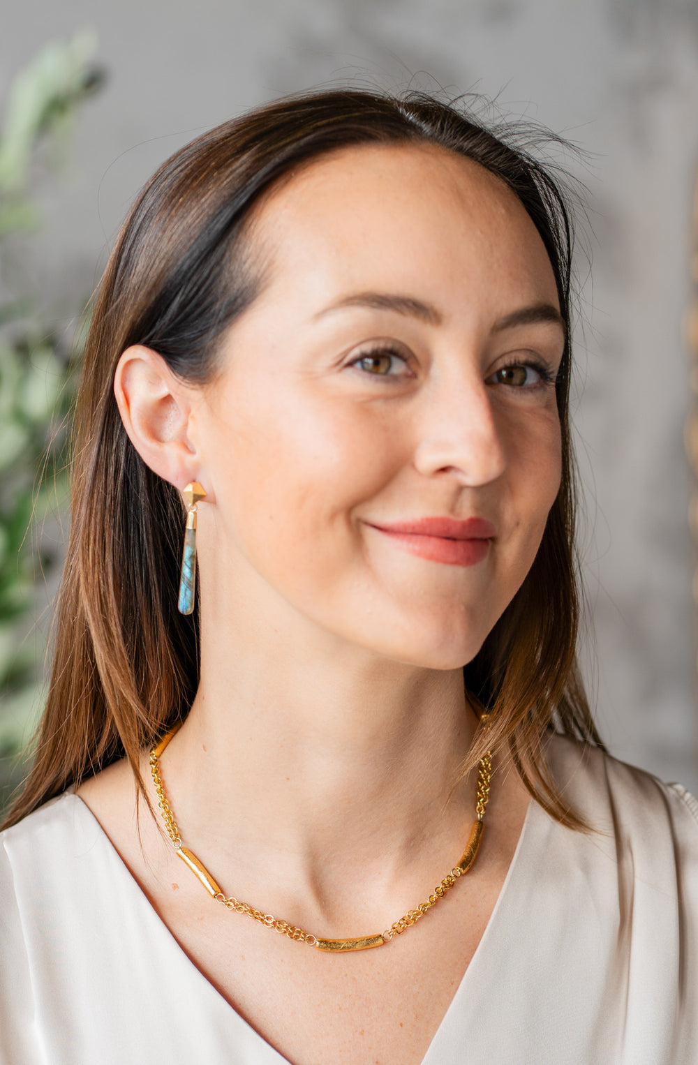 Gold-plated necklace with textured tube beads spaced along a double chain.