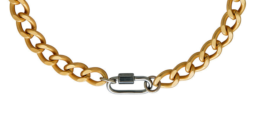 A chunky gold chainlink necklace with matte silver carabiner link.