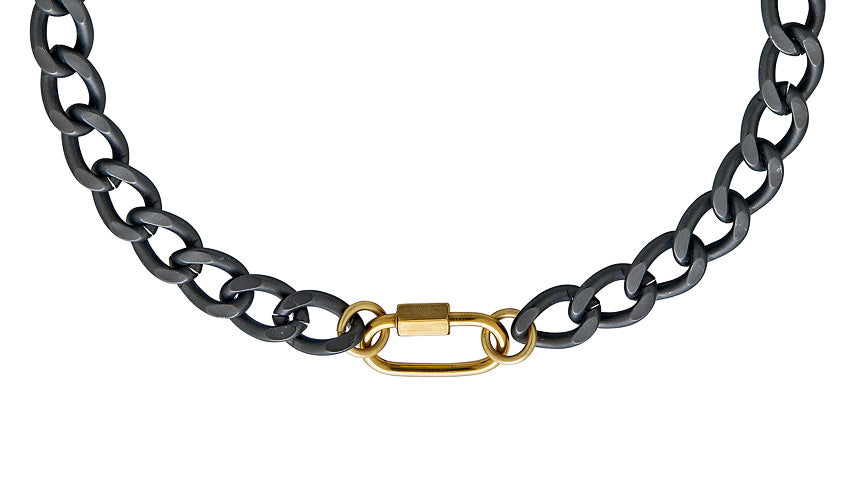 A chunky oval matte gunmetal chain necklace with gold carabiner link.