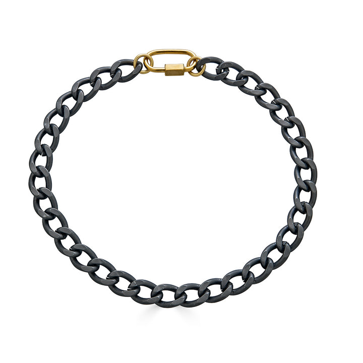 A chunky oval matte gunmetal chain necklace with gold carabiner link.