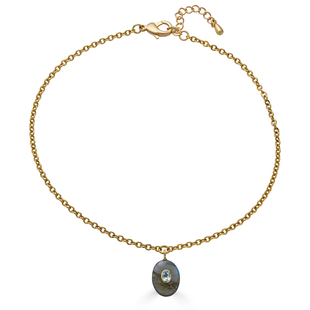 Oval labradorite pendant necklace with blue topaz inlay on a gold chain.