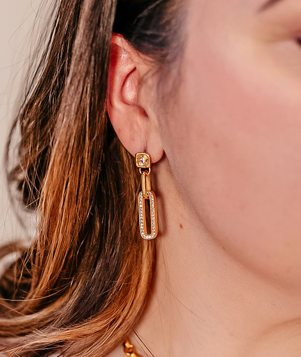 A woman modeling a pave drop crystal earring.