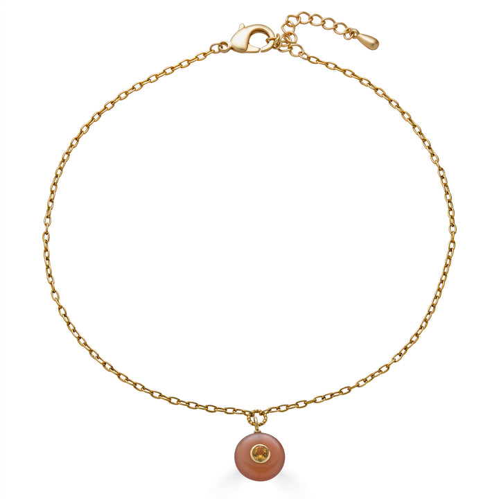 Peach moonstone pendant necklace with round citrine inlay on a gold elongated chain.
