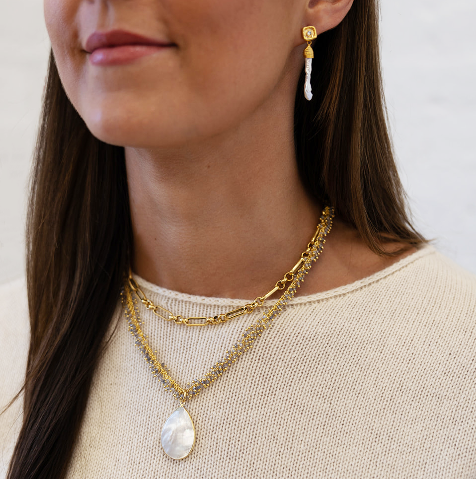 A labradorite drizzle necklace with a pearl pendant