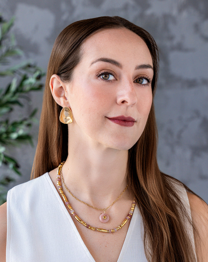 Matte gold sculptural scoop stud earrings with an organic curved shape and satin finish.