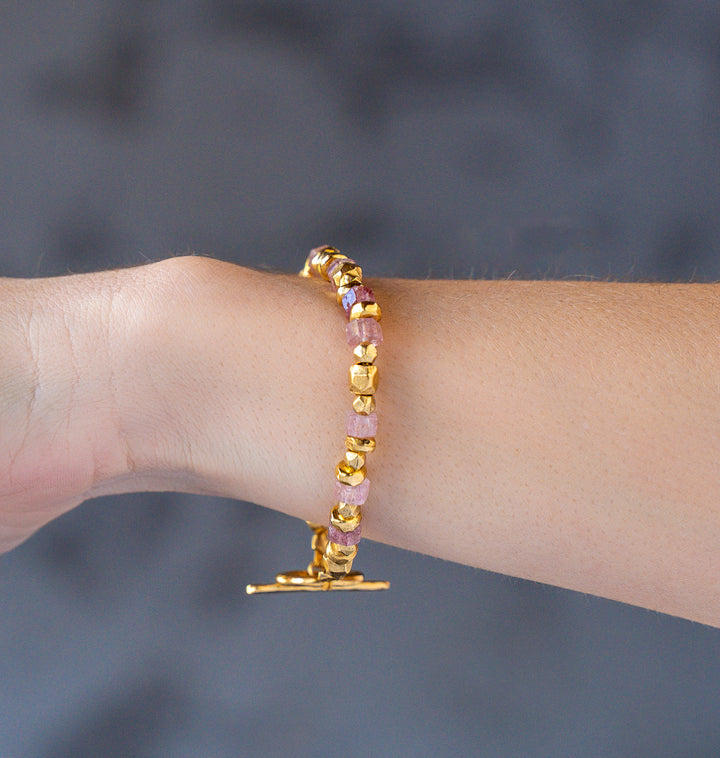 Pink strawberry quartz and gold bead bracelet with organic textured beads and toggle clasp.