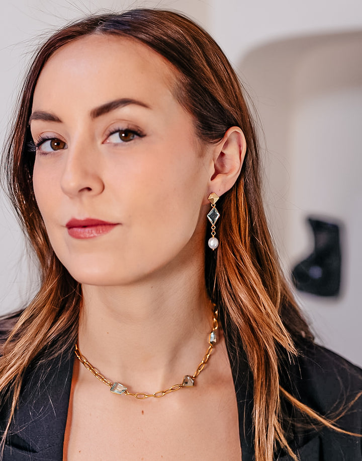 A model wearing A paperclip chain with fancy cut asymmetrical quartz crystals