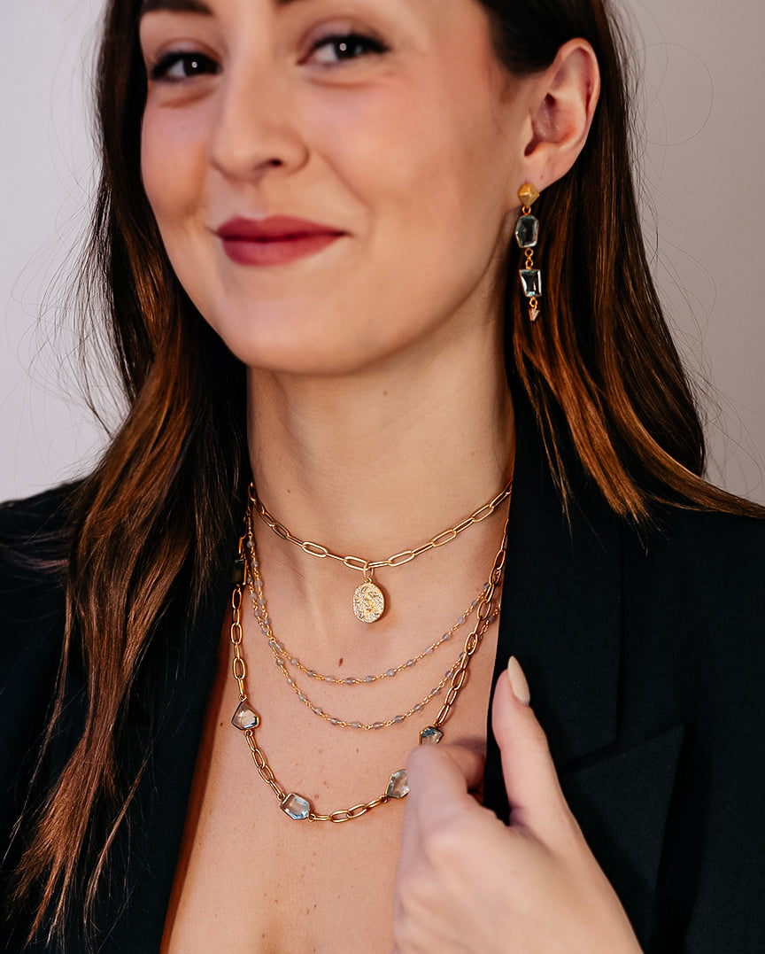 A model wearing A star and moon pendant on a delicate paperclip chain