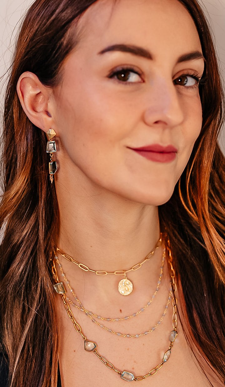 a model wearing a delicate two strand labradorite bead necklace.