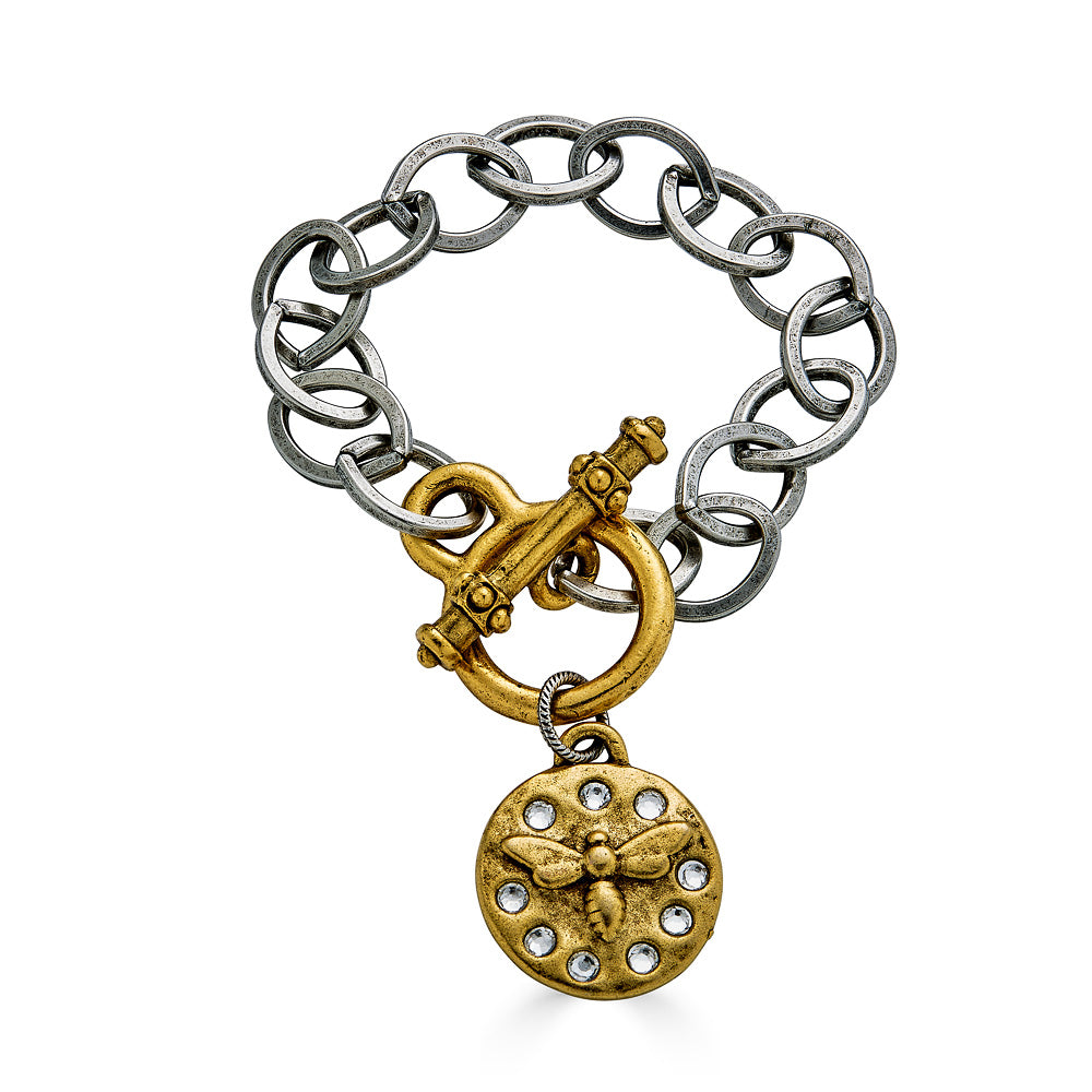 A silver chain link bracelet with a gold bee charm and toggle clasp.