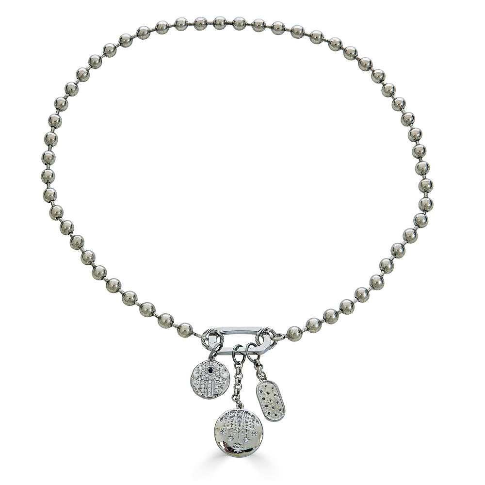 A ball chain charm necklace with fireworks, hamsa, and star charms on a snap clasp.