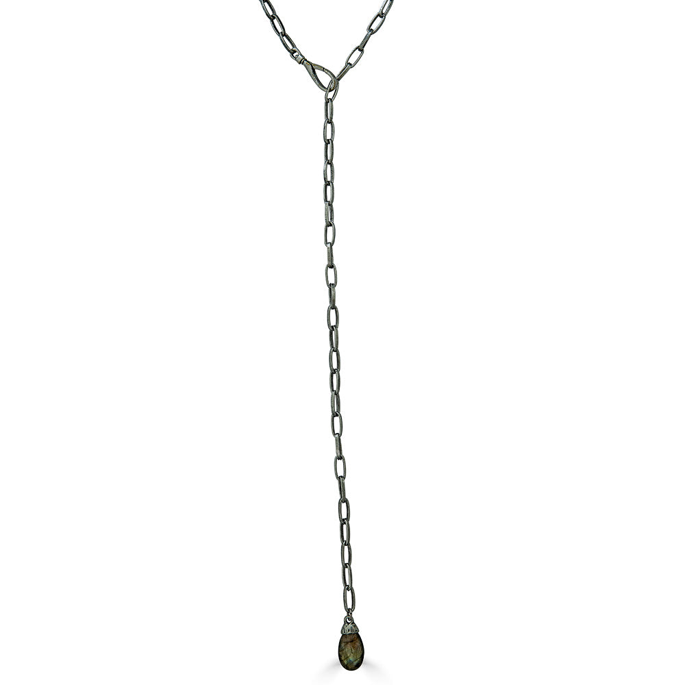 A silver lariat and labradorite pendant necklace.
