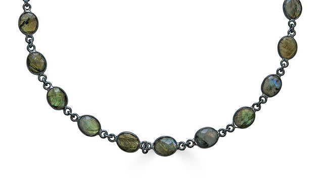 A bezel set labradorite necklace with pave clasp.