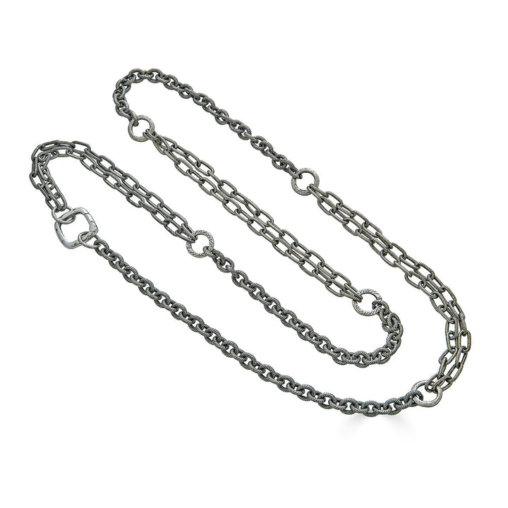 A silver multi-chain layering necklace with square clasp.